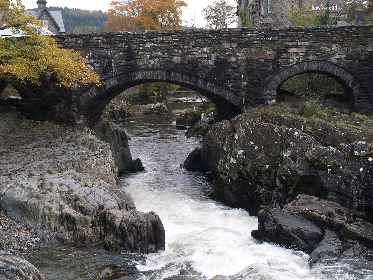 Stone arches of Pont y Pair above the rocky River Llugwy