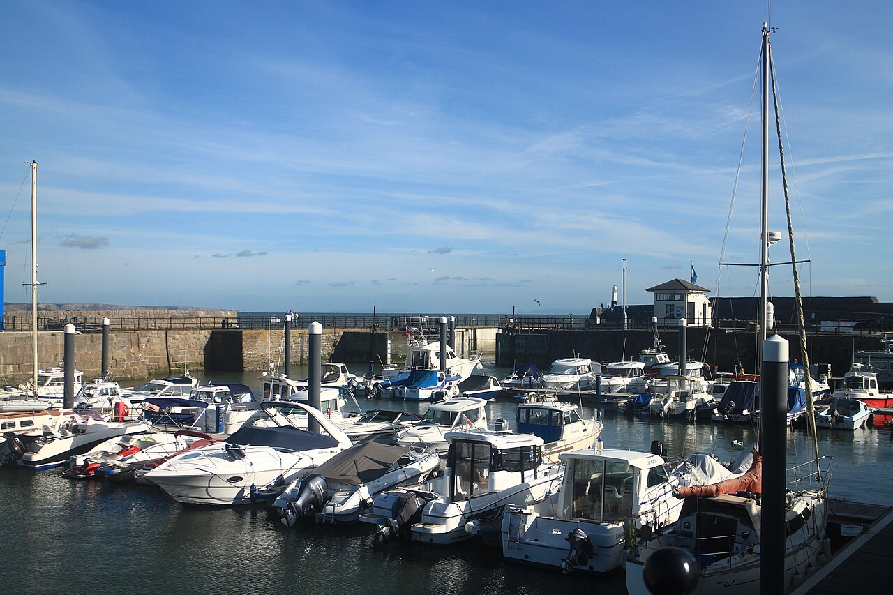 Porthcawl harbour and its white lighthouse beside the sea