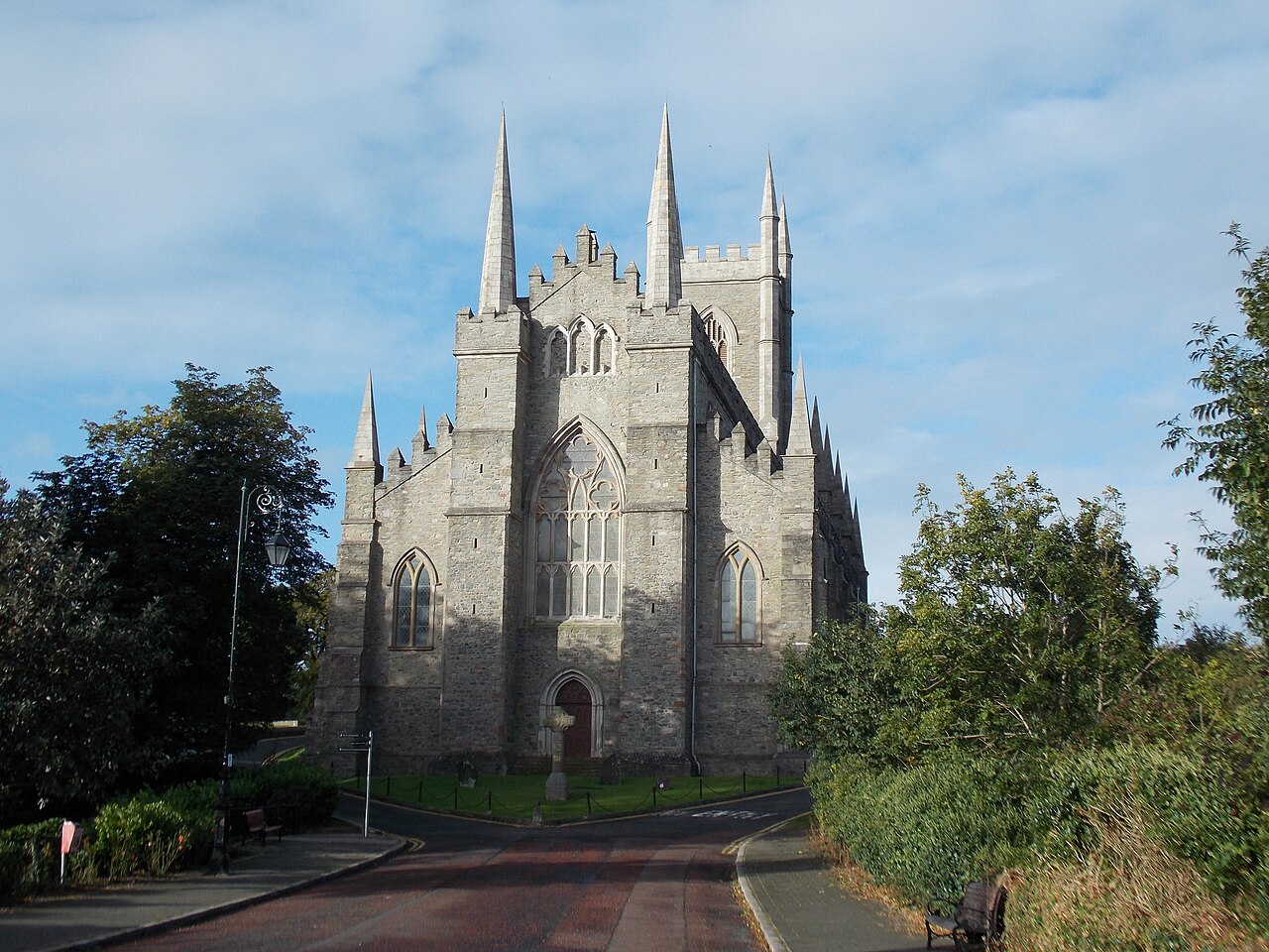 Stone cathedral with pinnacles above a path in Downpatrick