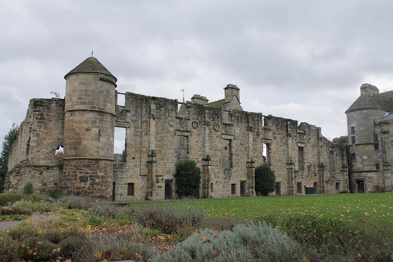 Stone north wing of Falkland Palace beside its garden