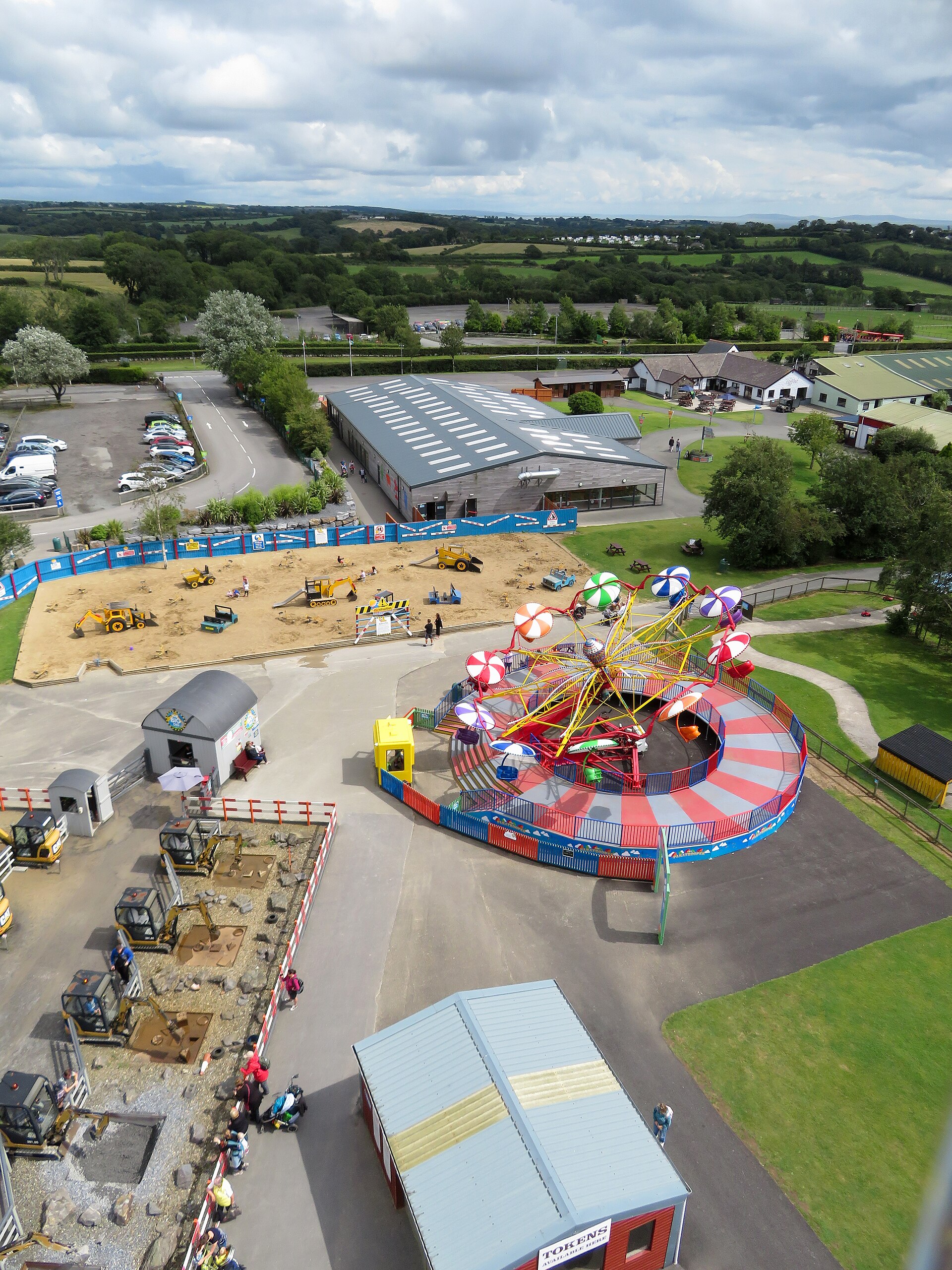View over fairground rides and buildings at Folly Farm