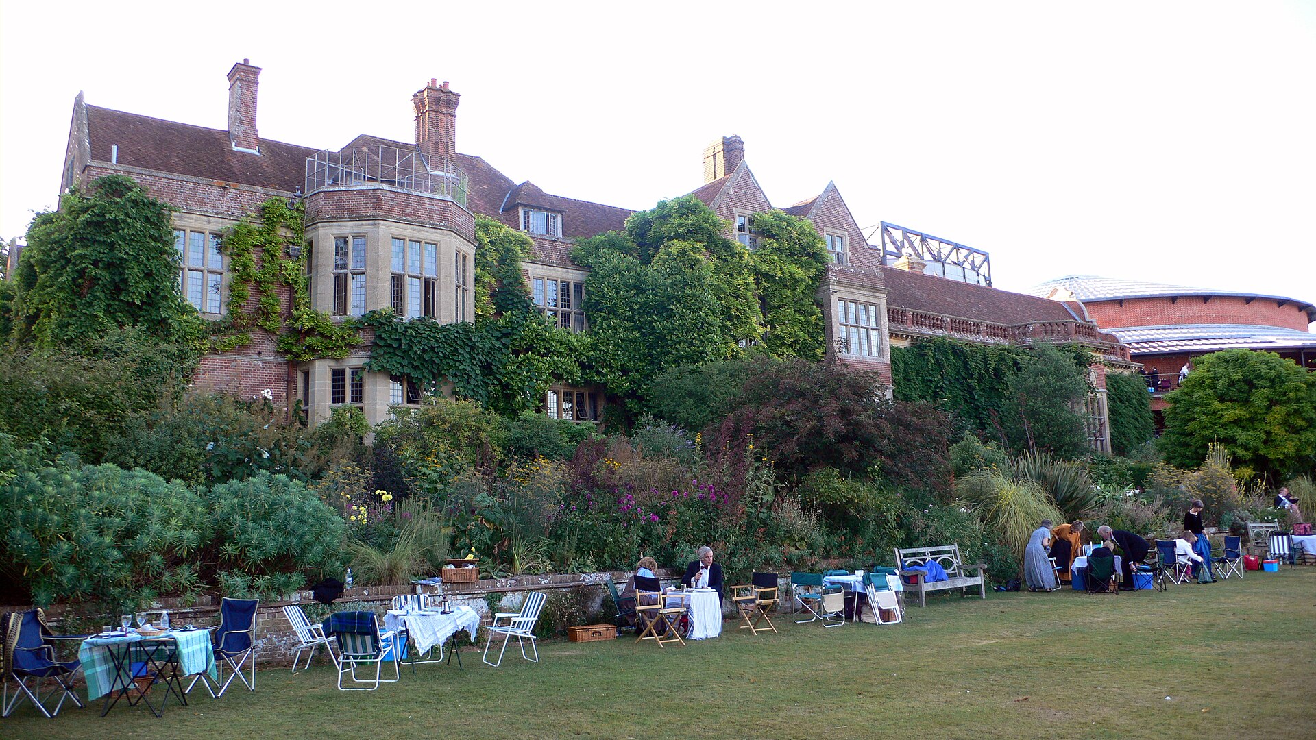 Picnic tables on Glyndebourne lawns beside the buildings