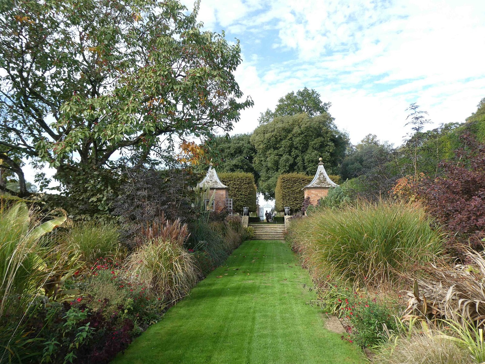 Red Borders and twin summer houses at Hidcote Manor Garden