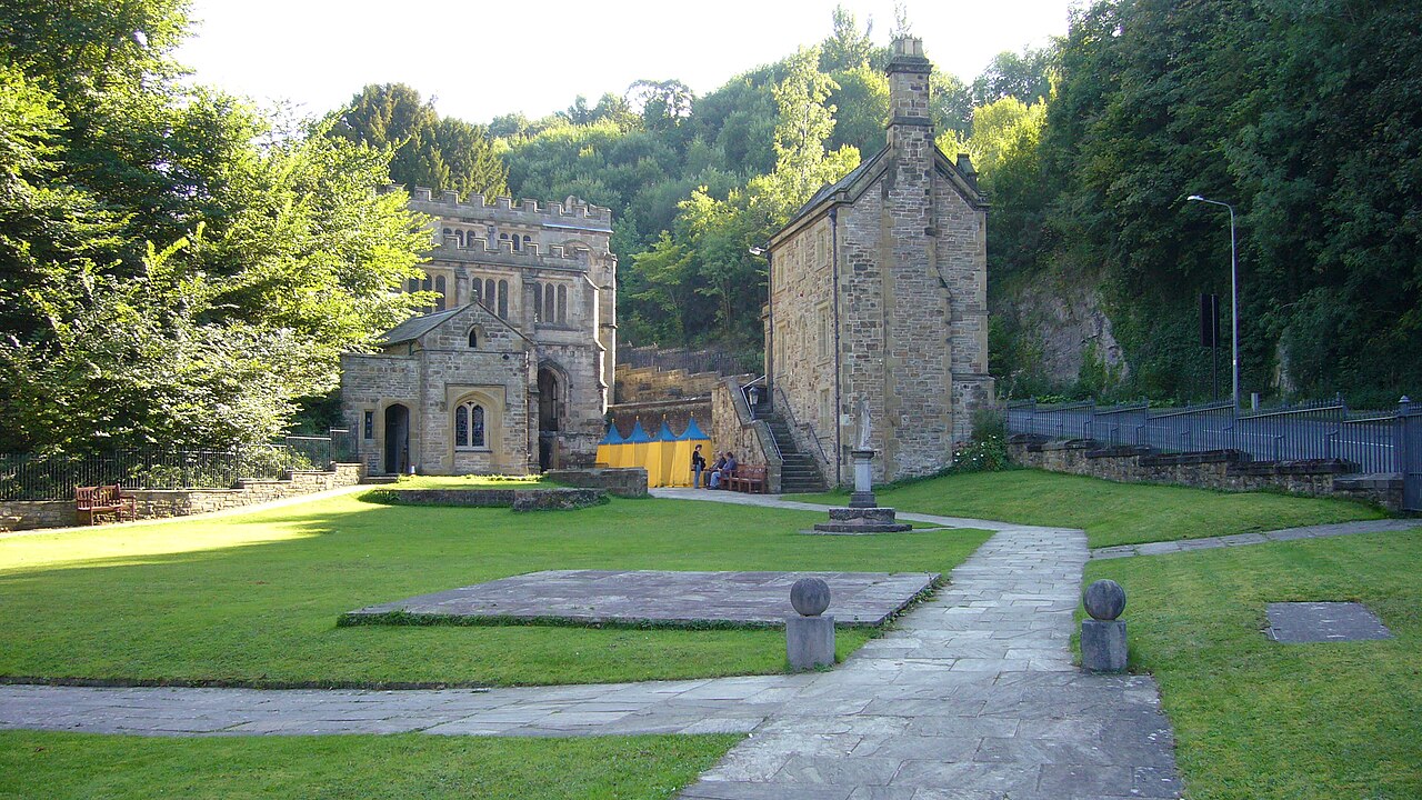Lawn and paths beside the stone shrine buildings at St Winefride’s Well, Holywell