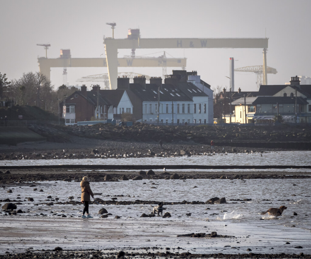 Holywood seafront with Belfast shipyard cranes across the lough