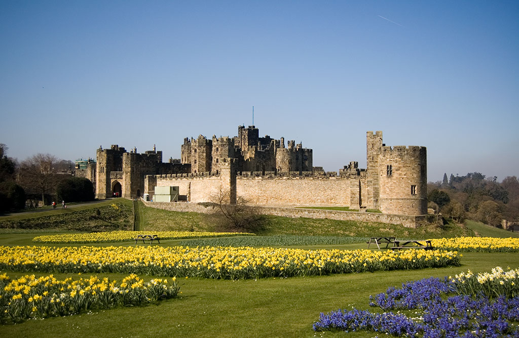 Alnwick Castle beyond spring gardens