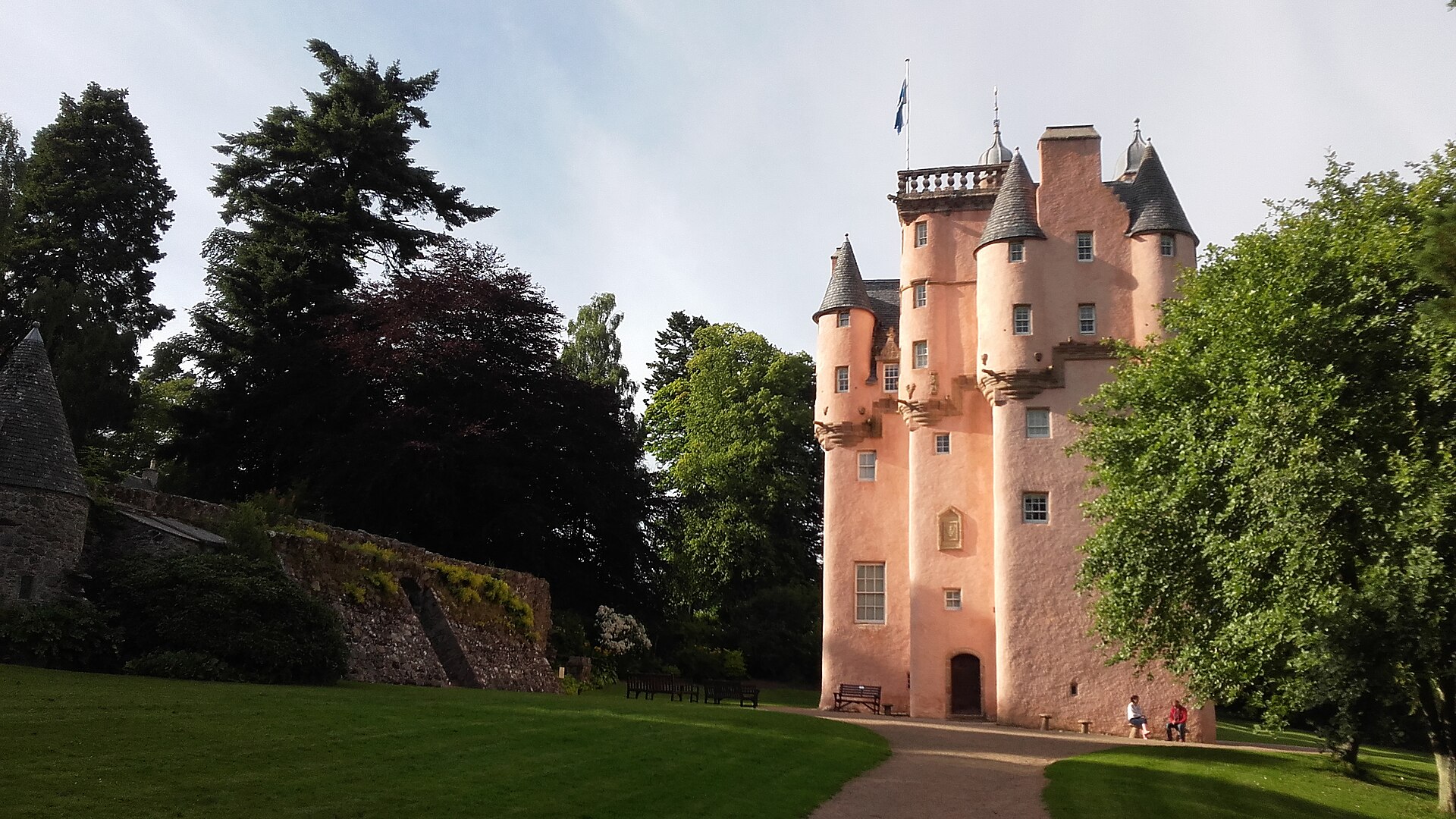 Pink Craigievar Castle tower above woodland in Aberdeenshire