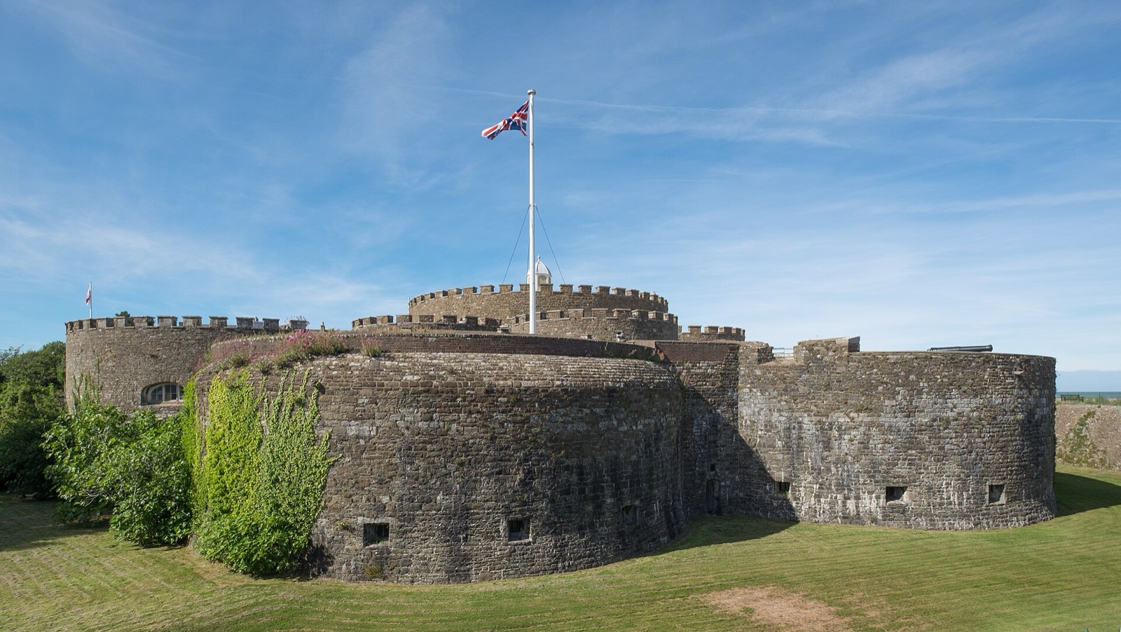 Rounded stone artillery bastions of Deal Castle under a blue sky