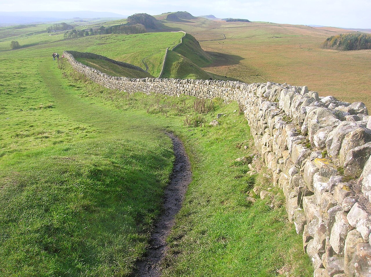 A surviving section of Hadrian's Wall across open countryside
