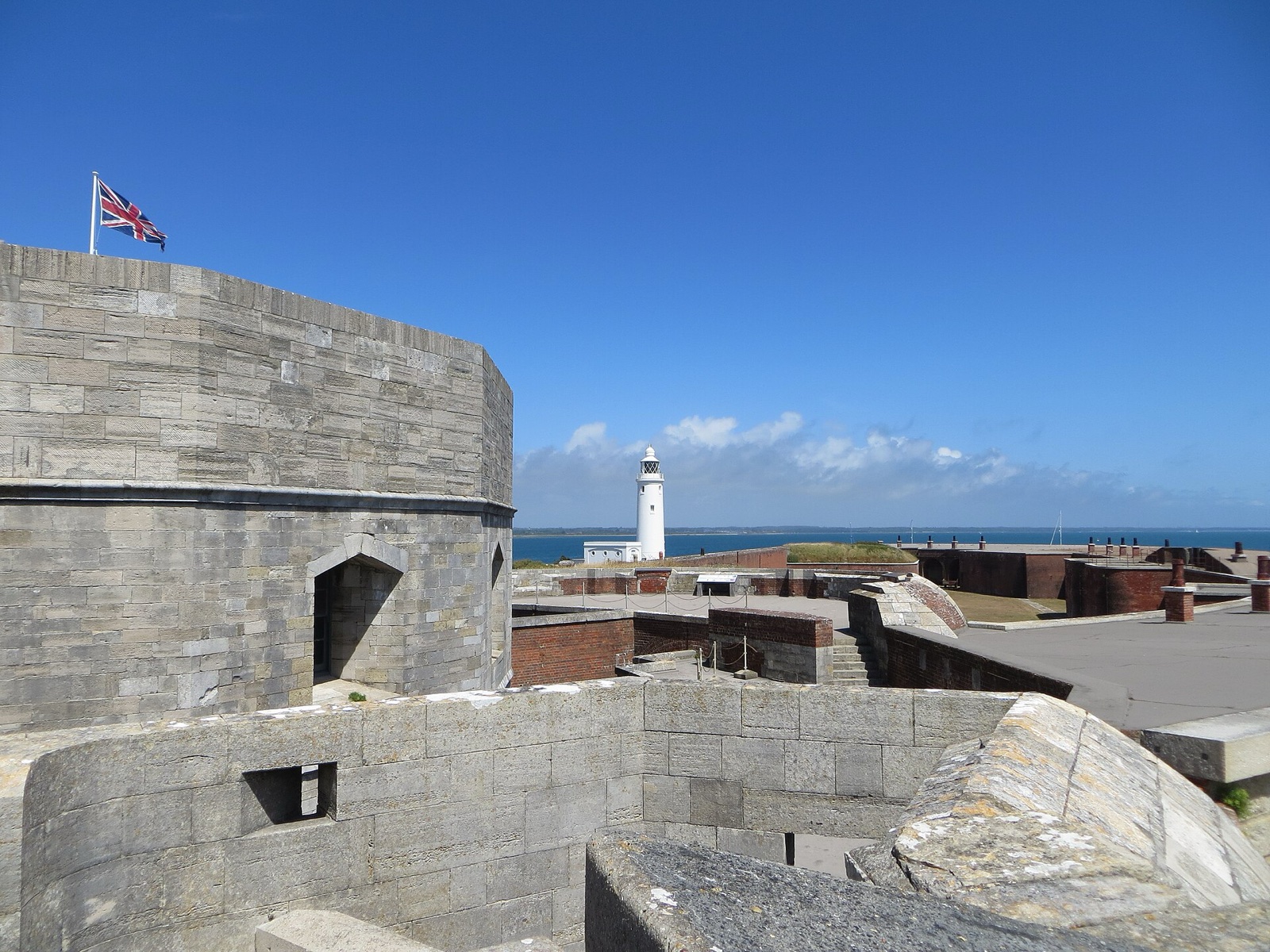 Tudor keep and later defences at Hurst Castle with the lighthouse beyond