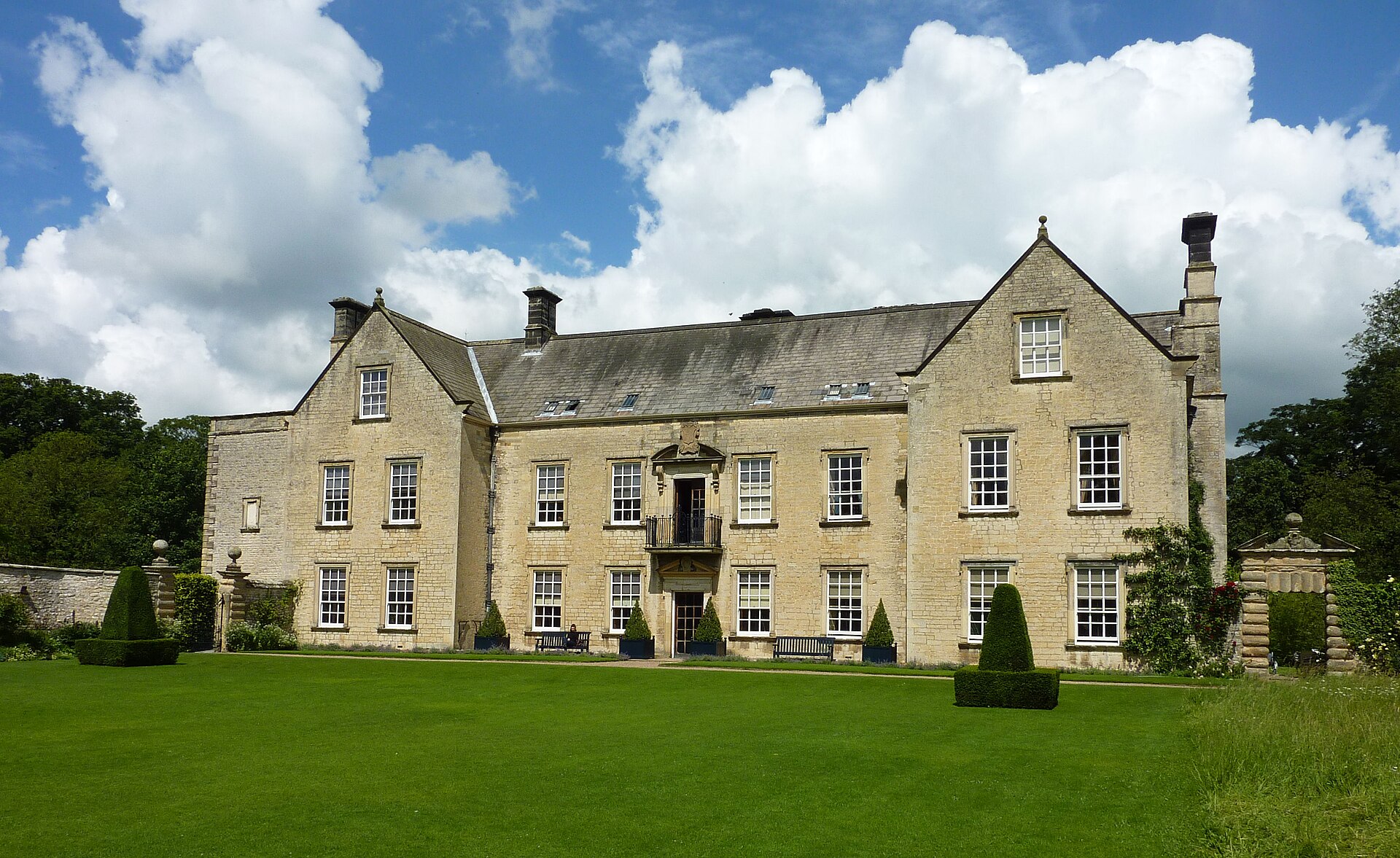 Stone south front of Nunnington Hall behind its garden