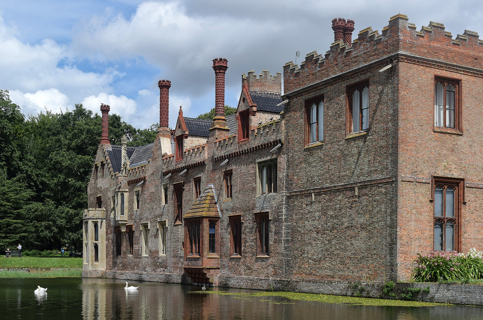 West facade of Oxburgh Hall reflected in its moat at Oxborough, Norfolk