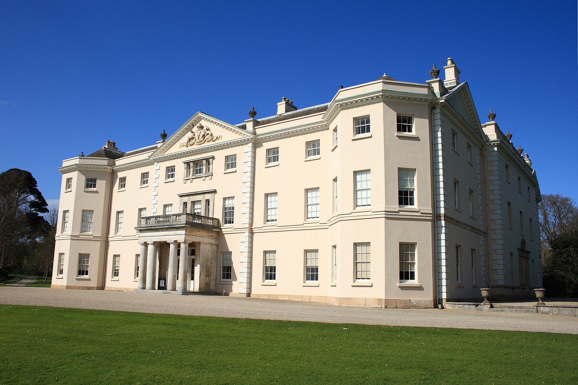 Georgian Saltram House facade and entrance beside its formal grounds