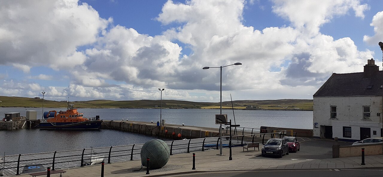 Lerwick waterfront and harbour beneath a cloud-filled sky