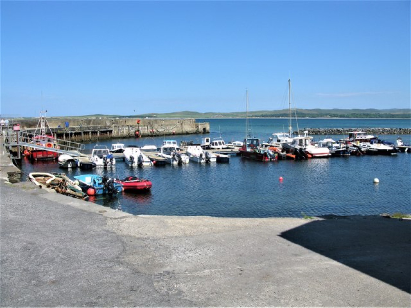 Boats moored at Bowmore harbour beside Loch Indaal