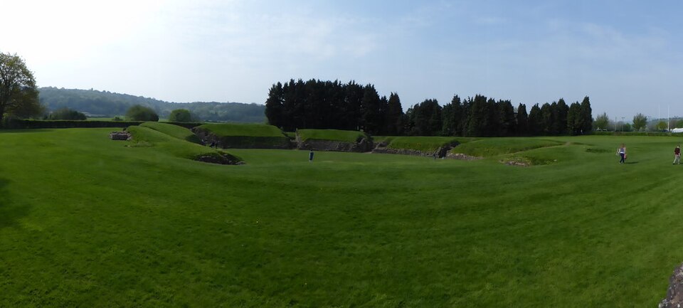 Grassy arena and Roman stone remains at Caerleon amphitheatre