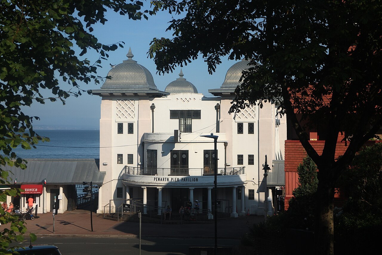 Penarth Pier Pavilion with the sea beyond, viewed through trees