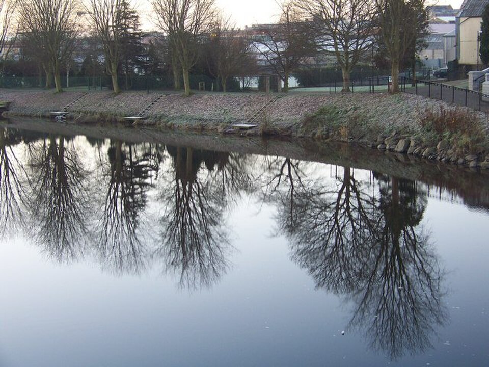 Trees and riverside steps reflected in the River Bann at Portadown