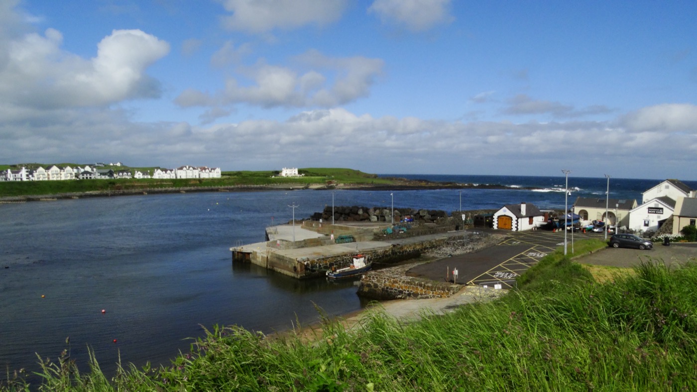 Portballintrae harbour with boats and the surrounding coast
