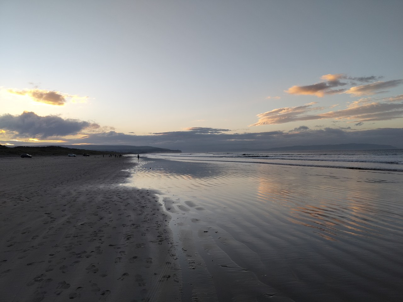Wet sand and sea at Portstewart Strand at sunset