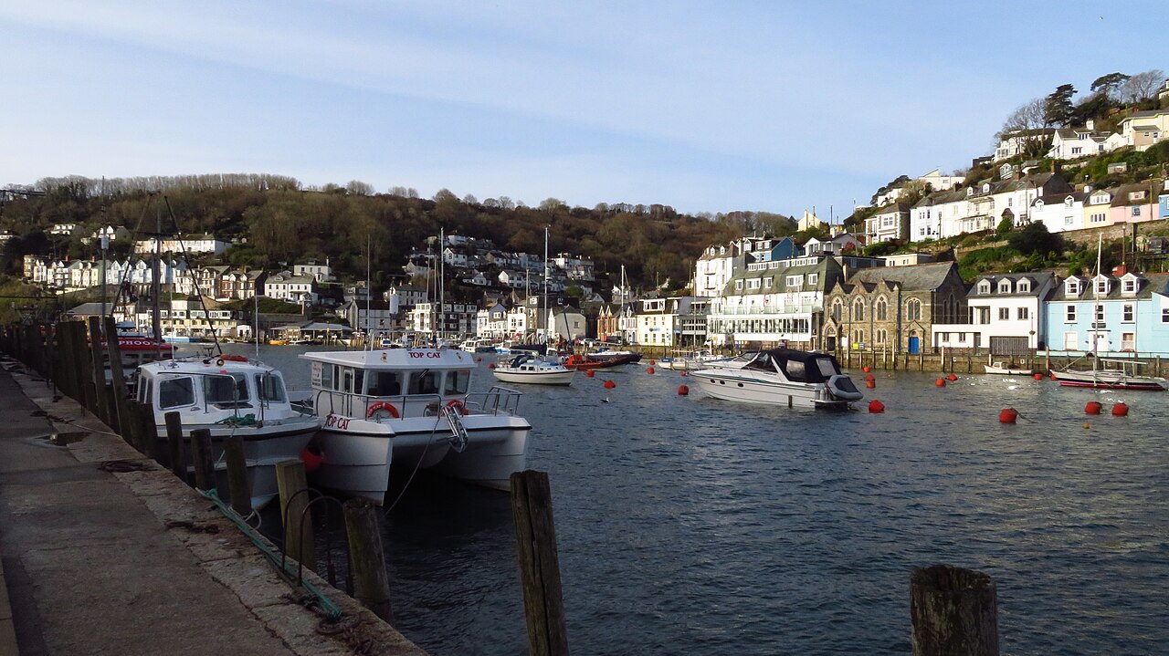 Boats moored opposite the waterfront buildings of West Looe