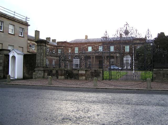 Hillsborough Castle behind its ornate village-side gates