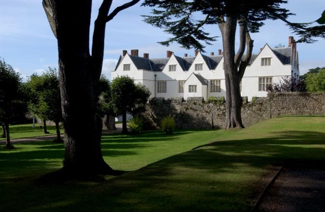 St Fagans Castle beyond mature trees and a garden lawn