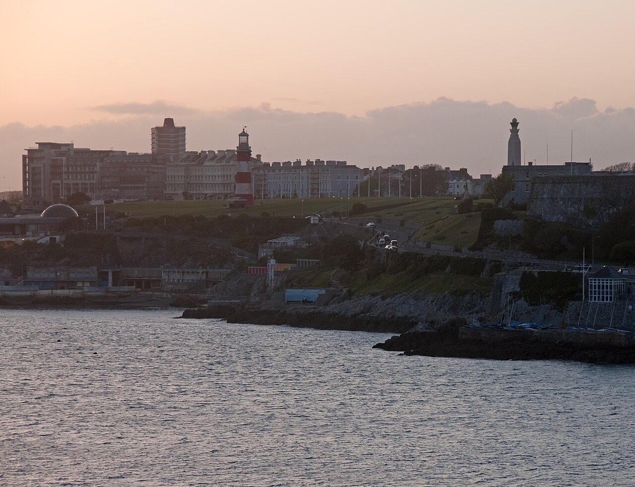 Plymouth Hoe and waterfront seen across the Sound at sunset