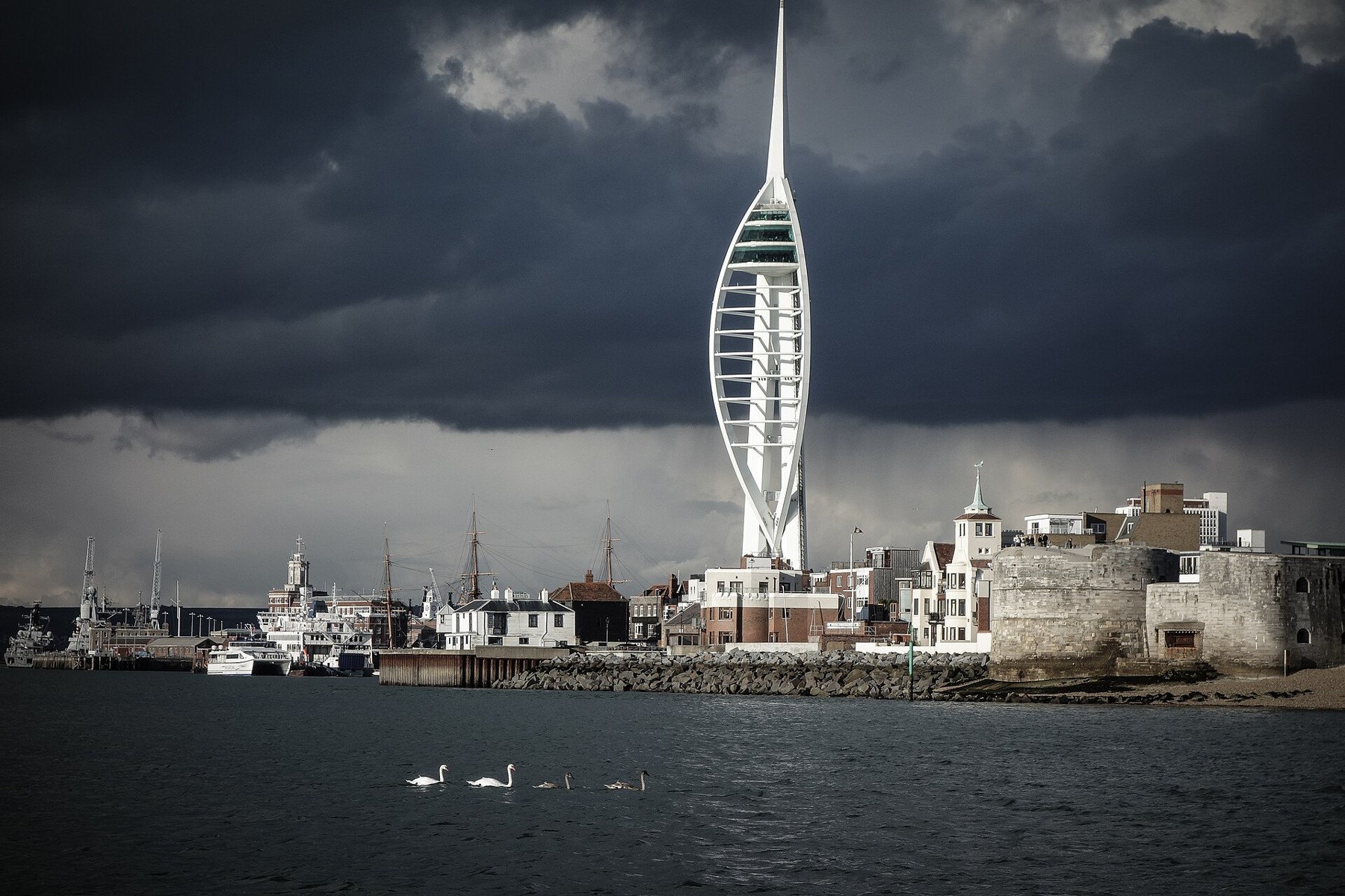 Spinnaker Tower above Portsmouth’s waterfront beneath dark clouds