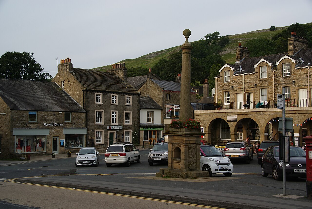 Historic stone buildings and market monument in Settle Market Place