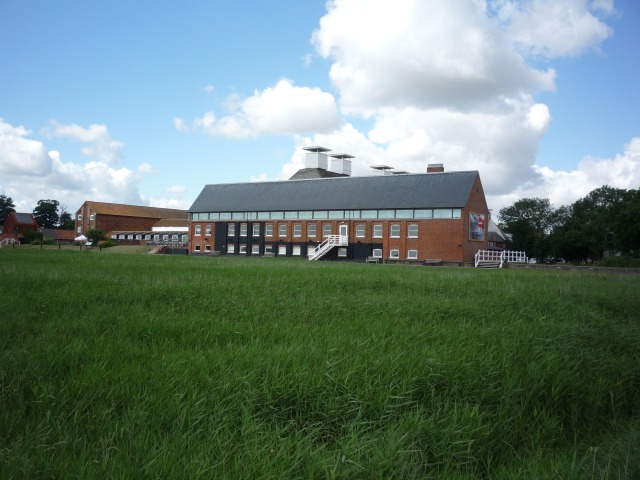 Red-brick Snape Maltings Concert Hall across a lawn