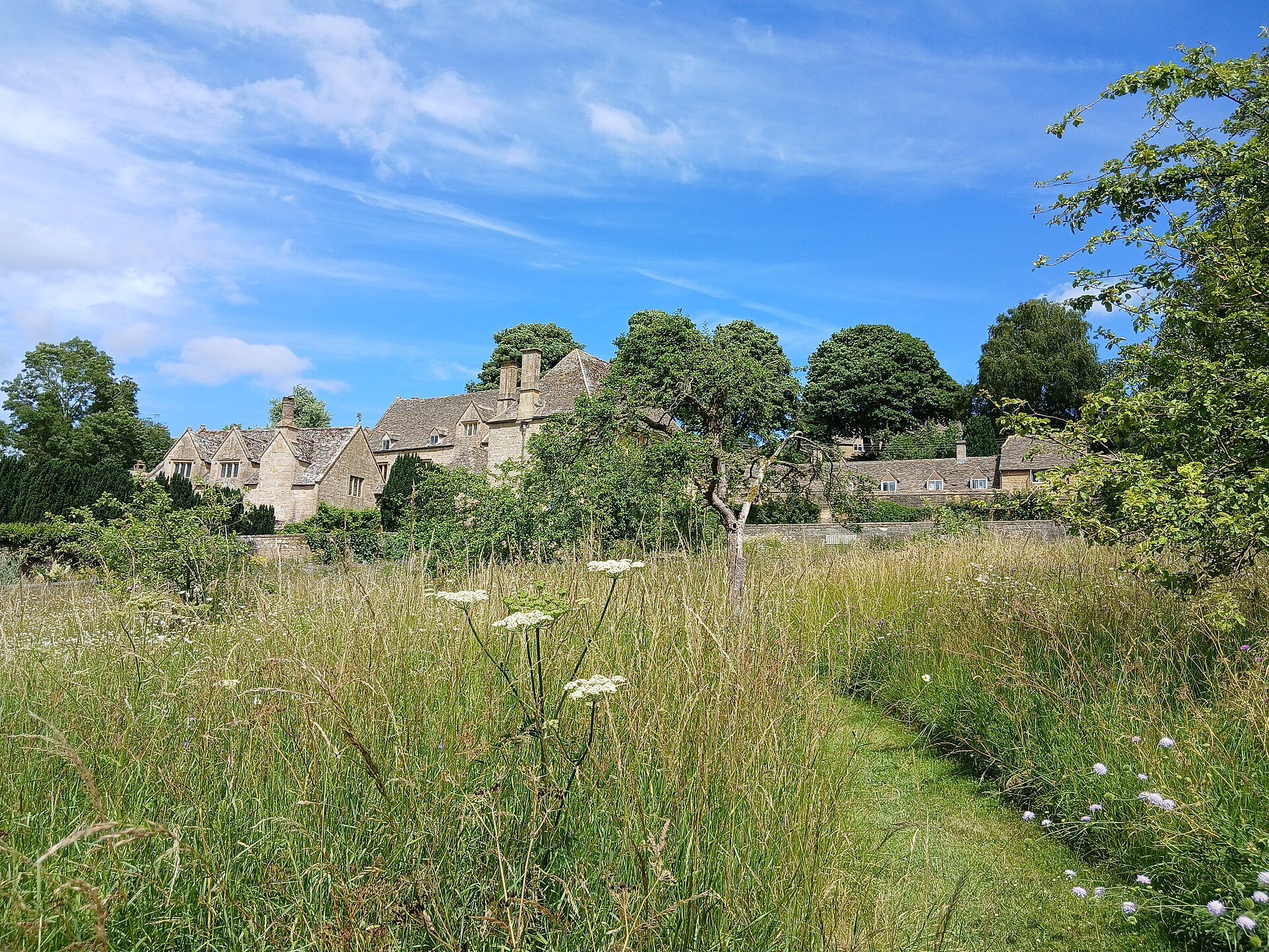 Snowshill Manor seen across its meadow