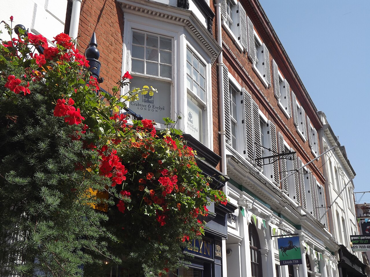 Flower baskets and historic shopfronts on Guildford High Street