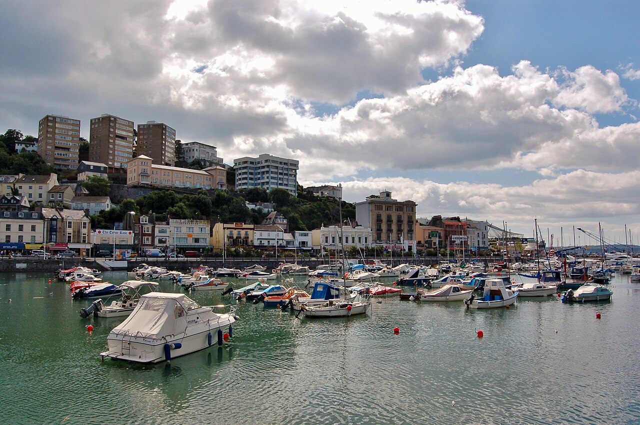 Boats and hillside waterfront buildings around Torquay harbour