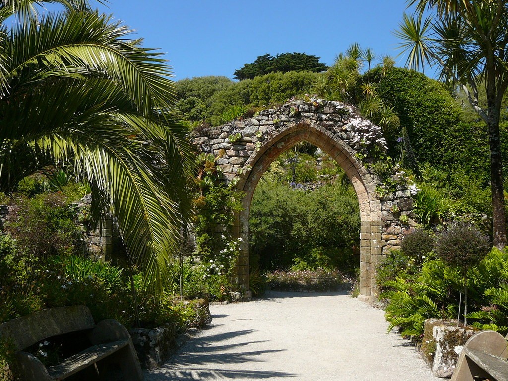 Stone arch and palms at Tresco Abbey Garden