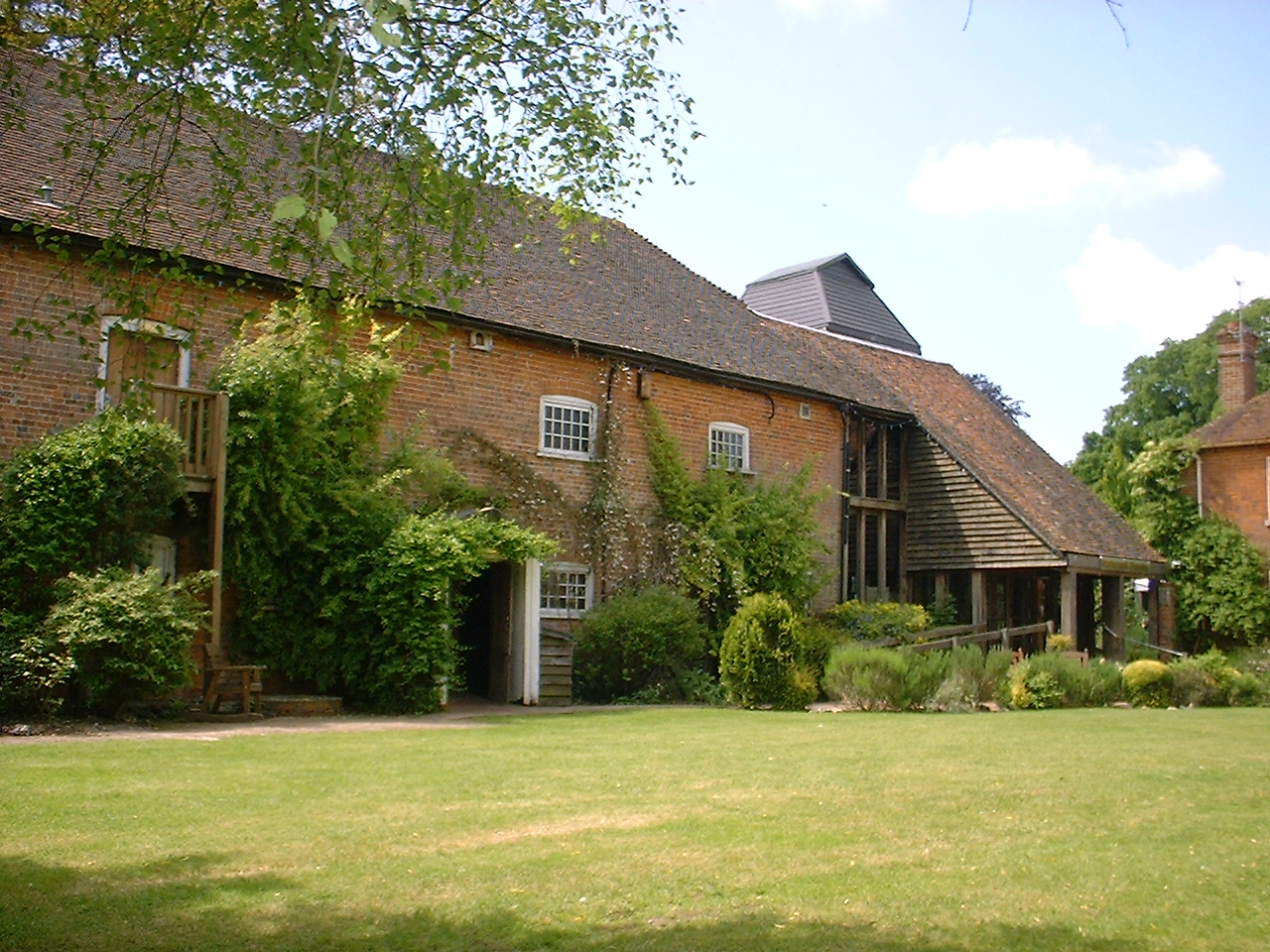 Brick Watermill Theatre building beside its garden at Bagnor