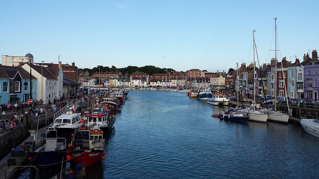 Boats and colourful waterfront buildings around Weymouth harbour